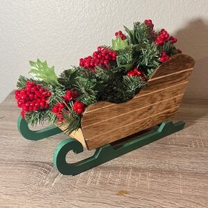 Festive Wooden Sleigh with Greenery and Red Berries